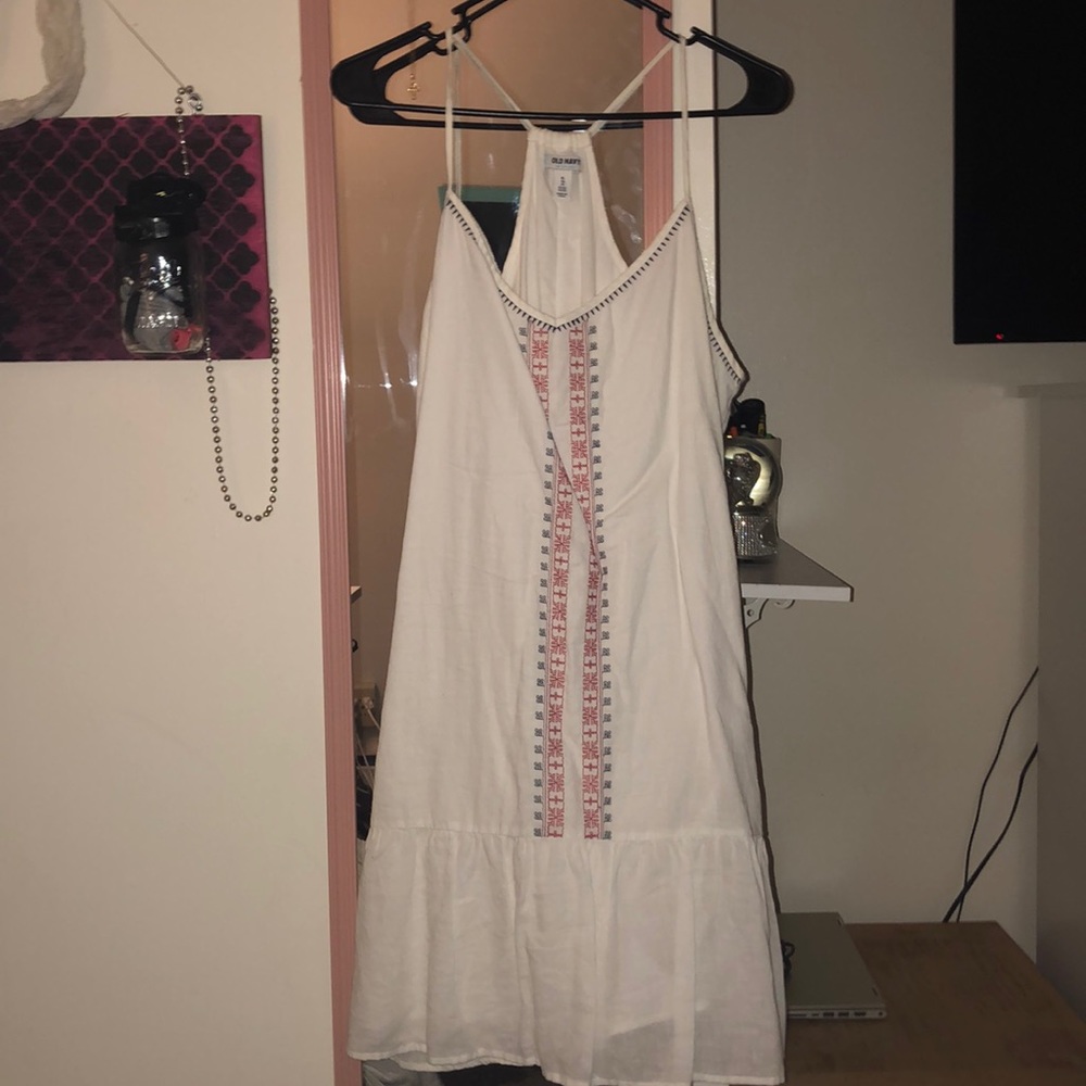 white flowy dress with blue and red details